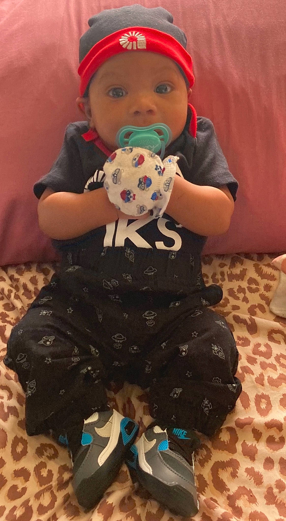 Dakari is registered to the contest to win money with this photo: baby_toddler_clothing, blue, cap, carmine, child, clothing, cool, dress, happy, headwear, one_piece_garment, pattern, person, pink, sitting, sleeve, t_shirt, textile, thigh, toddler