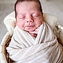 newborn, baby, sleeping, wrapped, blanket, beige, striped, basket, cozy, peaceful, infant, cute, soft, portrait, closeup, hands, face, resting, indoor, warm