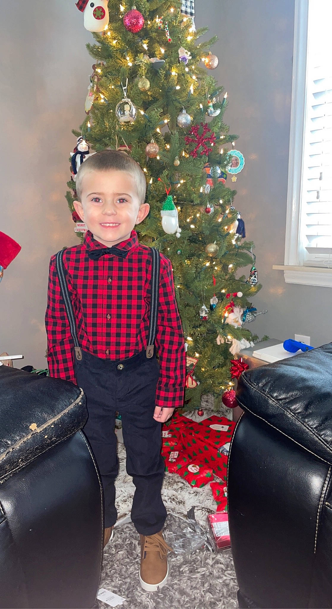 Carter is registered to the contest to win money with this photo: bag, christmas, christmas_decoration, christmas_ornament, christmas_tree, event, evergreen, happy, holiday, holiday_ornament, joy, luggage_and_bags, person, plaid, plant, red, smile, snapshot, standing, tartan