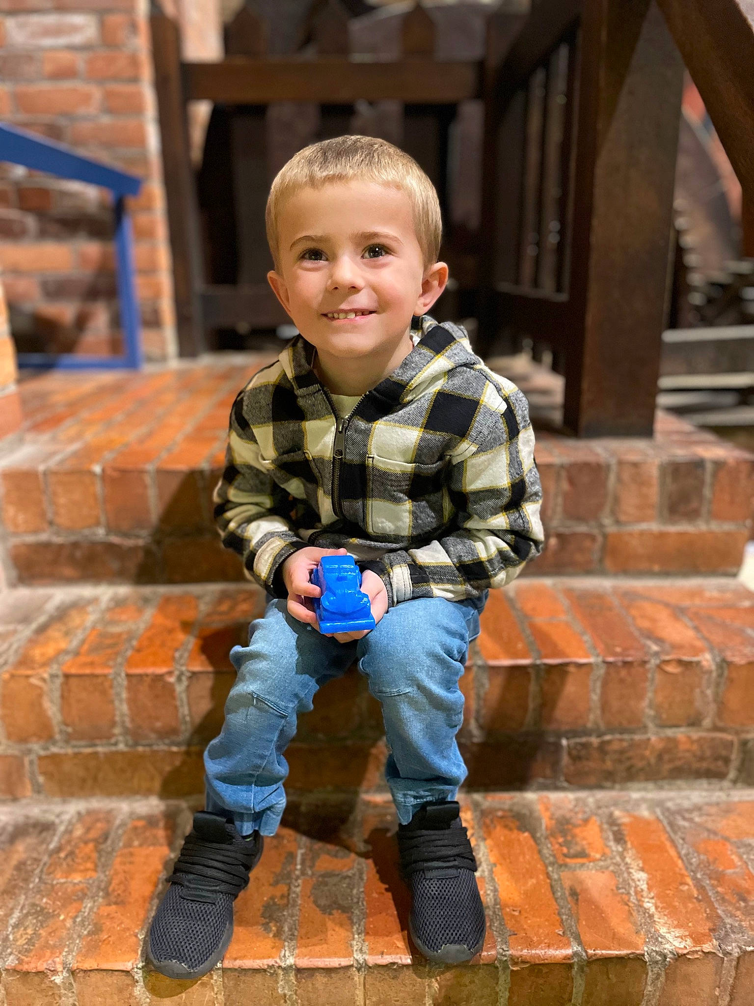 Carter is registered to the contest to win money with this photo: baby_toddler_clothing, brick, brickwork, eye, face, flash_photography, floor, flooring, fun, happy, human, jeans, joy, leg, orange, person, shoe, sleeve, smile, standing