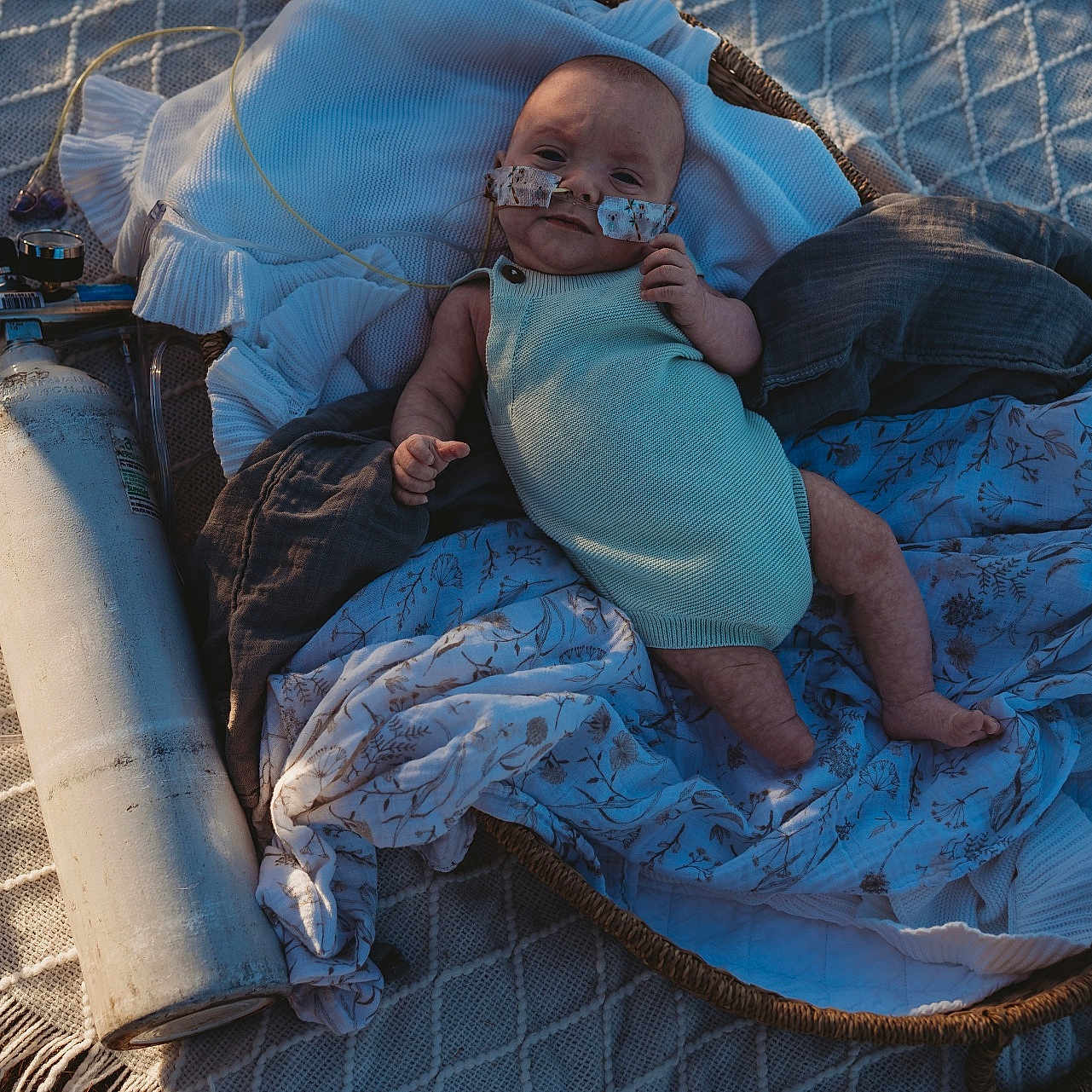 Braxton joined the competition — help win amazing prizes! baby, basket, blanket, closeup, cozy, cute, healthcare, infant, laying_down, light_and_shadow, medical_equipment, natural_light, newborn, outdoor, oxygen_tube, person, resting, soft_fabric, texture, young_child