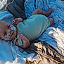 Braxton joined the competition — help win amazing prizes! baby, infant, basket, blanket, medical_tape, nasal_tube, clothing, lying_down, soft_lighting, indoors, portrait, cute, newborn, healthcare, child, person, resting, cozy, wrapped, skin