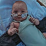 Braxton is registered to the contest to win money with this photo: baby, infant, nasal_tube, medical_tape, blanket, basket, knitted_clothing, lying_down, indoor, soft_lighting, closeup, person, skin, face, hand, newborn, cute, vulnerable, healthcare, resting