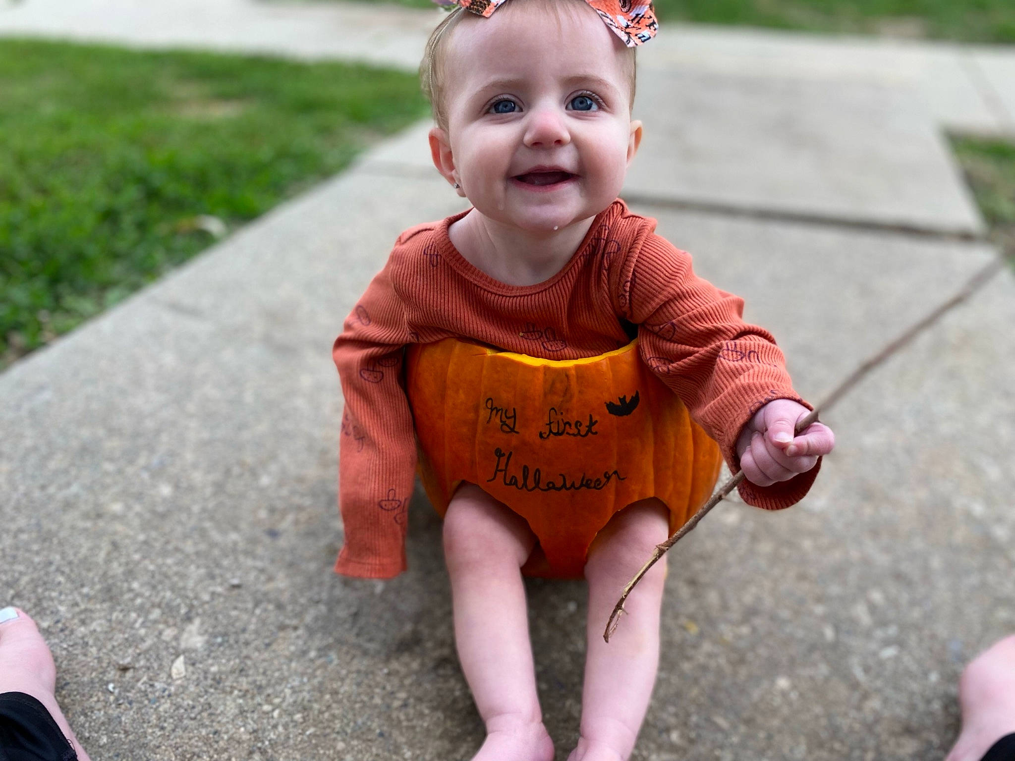 Hazel is registered to the contest to win money with this photo: baby, baby_toddler_clothing, clothing, dress, eye, face, facial_expression, finger, fun, grass, hairstyle, happy, head, joy, leaf, person, photograph, pink, plant, skin