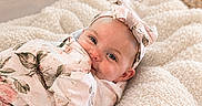 Esmae is registered to the contest to win money with this photo: baby, blanket, blue_eyes, child, closeup, comfort, cozy, cute, flower_pattern, happy, headband, indoor, infant, portrait, resting, smiling, soft_texture, toddler, warm, wrapped