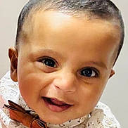 Elhan is registered to the contest to win money with this photo: baby, child, smiling, face, boy, bow_tie, clothing, cute, portrait, happy, infant, closeup, young, person, head, eyes, skin, fashion, expression, indoors