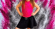 background, bright, child, colorful, confident, dance, event, explosion, girl, long_hair, pink, portrait, posing, powder, silver, skirt, smile, standing, text_overlay, top