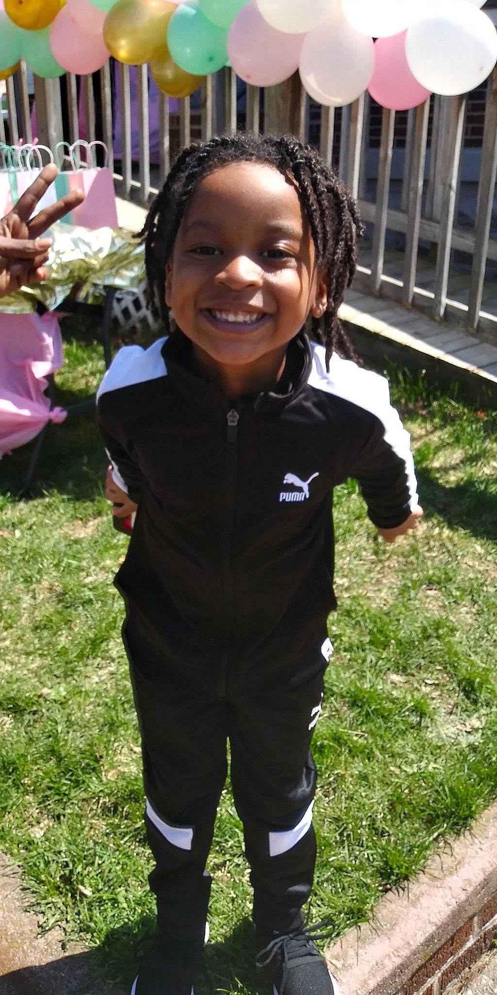 Iy'Kease is registered to the contest to win money with this photo: child, grass, joy, outerwear, person, plant, smile, t_shirt, toddler, uniform