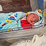 Sejong joined the competition — help win amazing prizes! newborn, baby, sleeping, blanket, hospital, bassinet, hat, red_clothing, blue_blanket, infant, child, cute, peaceful, indoor, portrait, soft_lighting, nursery, resting, baby_bed, wrapped
