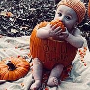 Roper is registered to the contest to win money with this photo: baby, child, pumpkin, orange_hat, candy_corn, blanket, autumn_leaves, outdoor, fall, cute, sitting, fall_holiday, harvest, seasonal, baby_pose, baby_face, festive, holiday, nature, playful