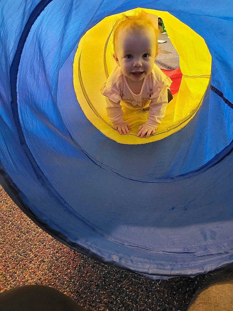 Novalee is registered to the contest to win money with this photo: baby, baby_toddler_clothing, child, circle, electric_blue, fun, happy, inflatable, leisure, outdoor_play_equipment, person, play, playground, recreation, sitting, smile, symmetry, tints_and_shades, toddler