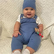 Thiago is registered to the contest to win money with this photo: baby, beanie, bodypart, bonnet, cap, clothing, couch, face, finger, furniture, glove, hand, hat, head, hosiery, pants, person, photography, portrait, sock