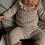 Ariella joined the competition — help win amazing prizes! baby, child, infant, headband, bow, boots, knitwear, sitting, couch, cozy, portrait, cute, fashion, indoor, clothing, warm, soft_lighting, neutral_colors, face, expression