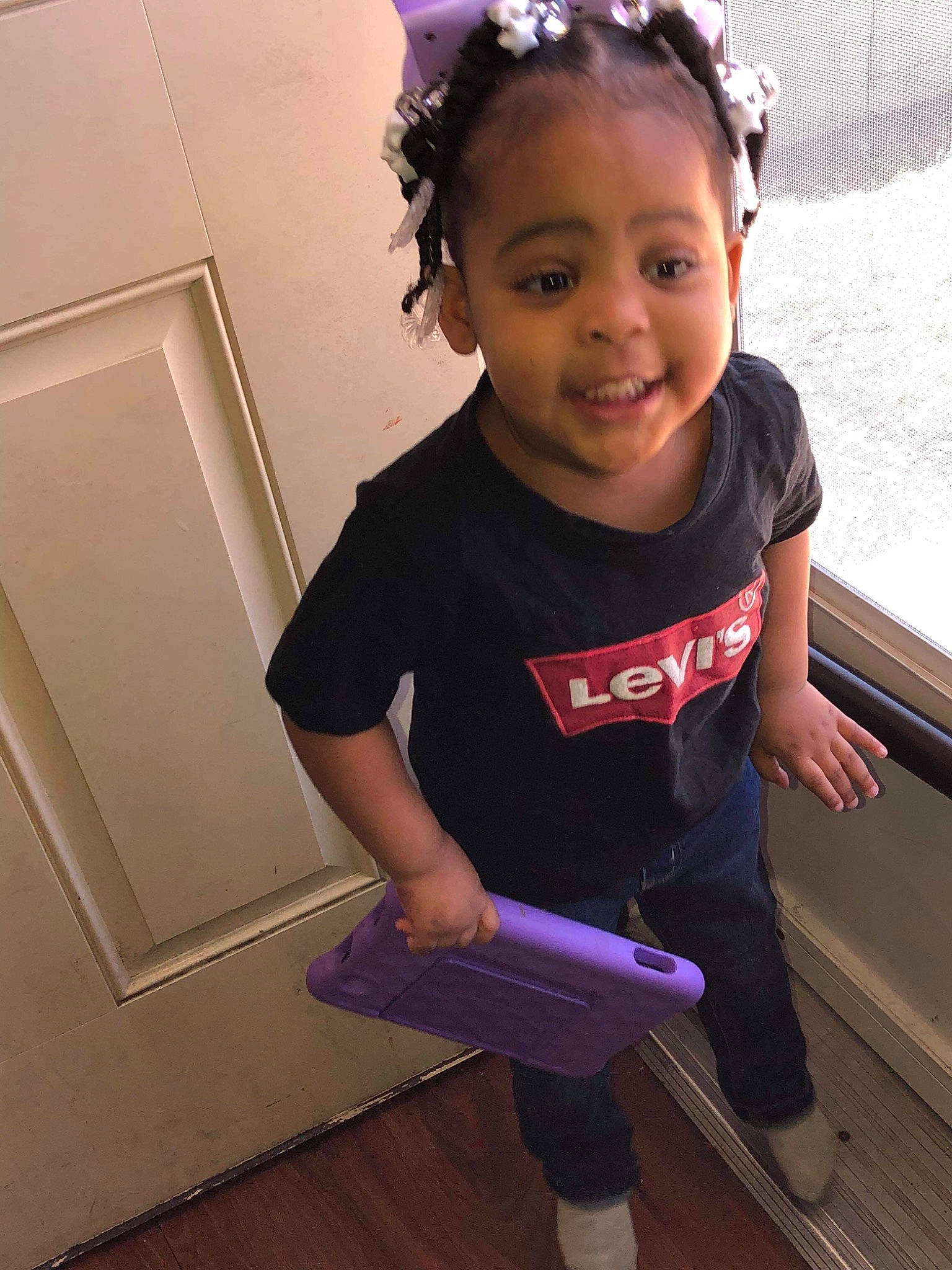 Delilah is registered to the contest to win money with this photo: baby_toddler_clothing, child, cool, facial_expression, flooring, fun, hairstyle, happy, headband, magenta, person, pink, product, purple, skin, sleeve, smile, standing, t_shirt, toddler