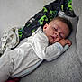 Selym is registered to the contest to win money with this photo: baby, sleeping, pajamas, blanket, couch, face, child, indoor, resting, peaceful, soft, cozy, person, infant, head, closed_eyes, comfort, young, cute, relaxing