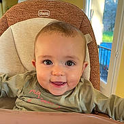Maddie participe au concours pour gagner de l'argent avec cette photo : baby, chicco, child, clothing, cute, eyes, face, furniture, hair, happy, high_chair, indoors, light, mouth, person, sitting, skin, smiling, tongue, window