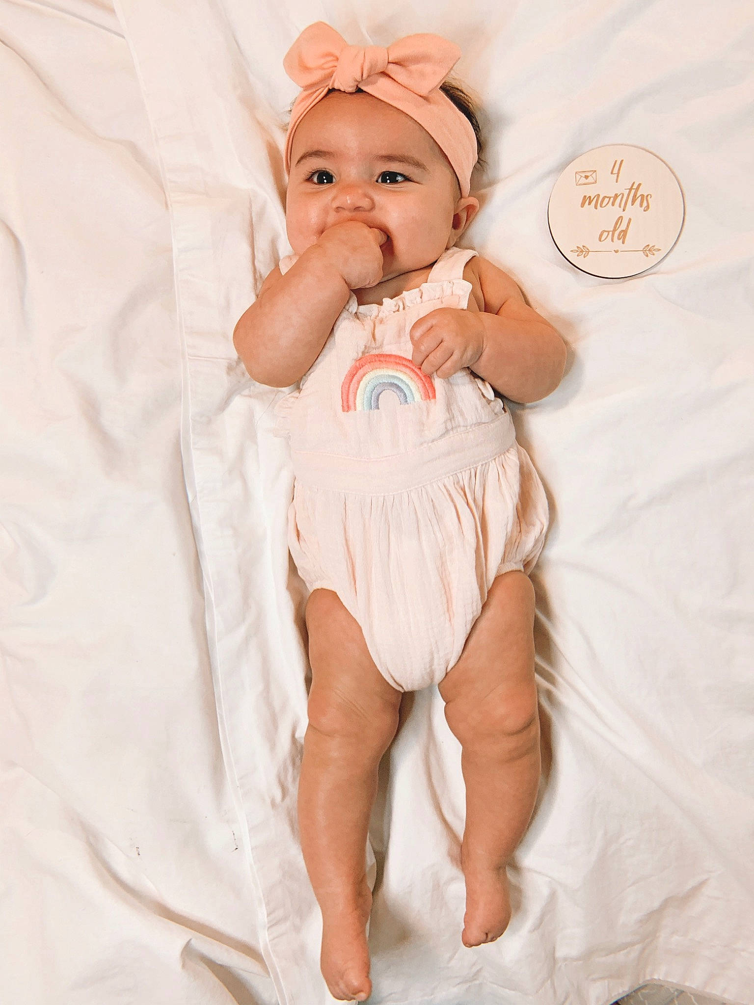 Aribella is registered to the contest to win money with this photo: abdomen, baby, baby_toddler_clothing, child, comfort, dress, eye, foot, happy, headwear, human_leg, knee, linens, person, pink, sleeve, sock, stomach, textile, thigh