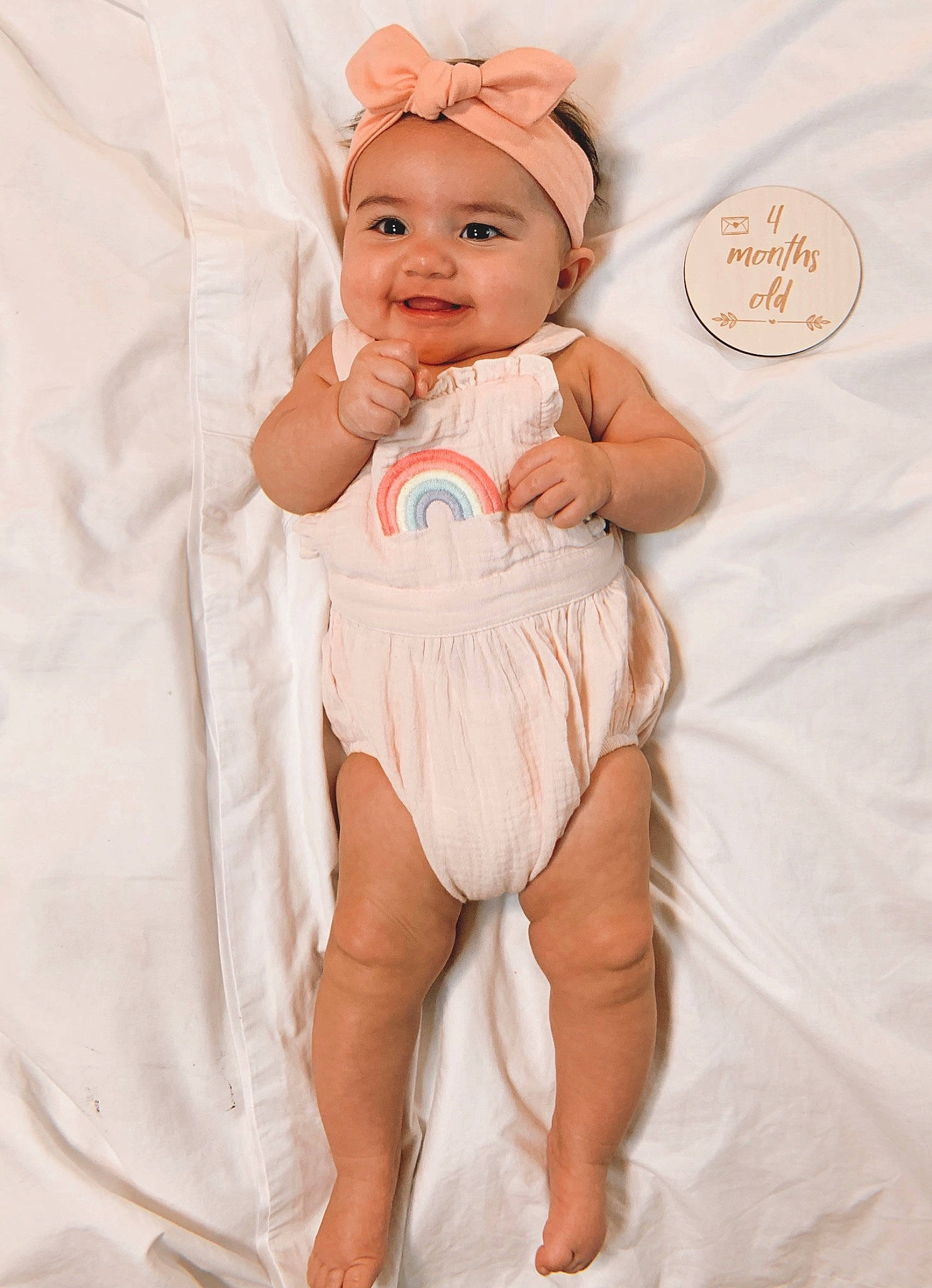 Aribella is registered to the contest to win money with this photo: abdomen, arm, baby, baby_toddler_clothing, comfort, eye, face, finger, hand, happy, headwear, human_leg, joy, person, pink, skin, sleeve, smile, stomach, textile