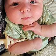 Riley is registered to the contest to win money with this photo: baby, infant, face, hand, pacifier, blanket, clothing, cute, skin, expression, person, resting, indoors, closeup, young, child, soft, comfort, sleepy, cozy