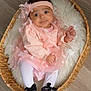 baby, infant, wicker_basket, faux_fur_blanket, pink_dress, headband, bow, tights, black_shoes, smile, wide_eyes, portrait, indoors, wooden_floor, cozy, soft_texture, sitting, hands, legs, cute