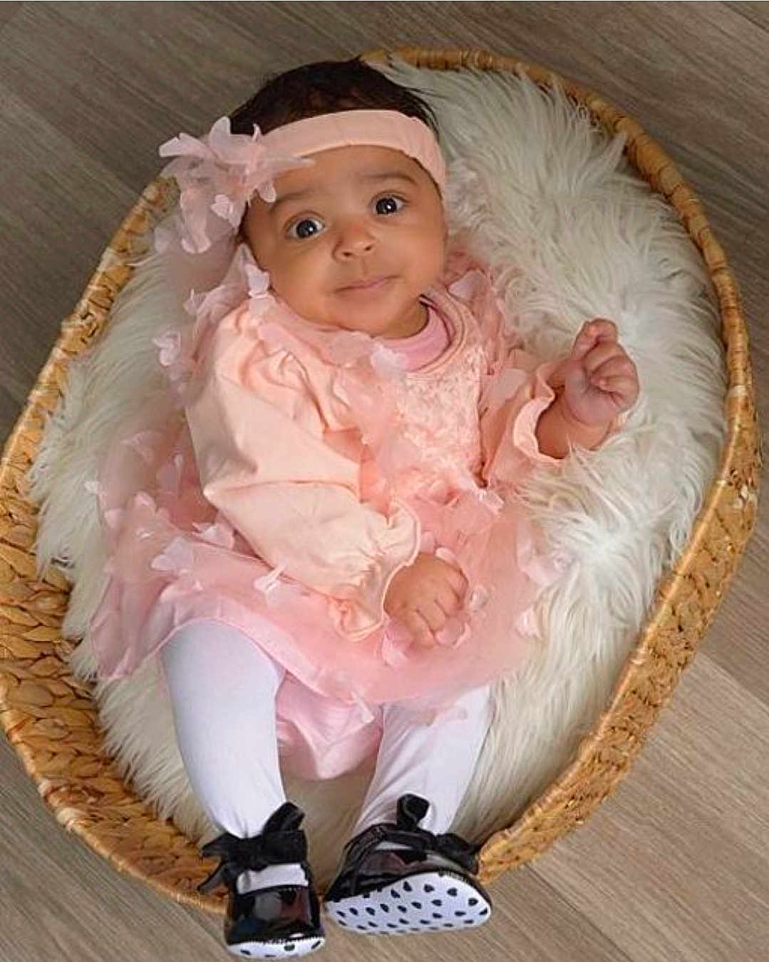Maecii joined the competition — help win amazing prizes! baby, infant, wicker_basket, faux_fur_blanket, pink_dress, headband, bow, tights, black_shoes, smile, wide_eyes, portrait, indoors, wooden_floor, cozy, soft_texture, sitting, hands, legs, cute