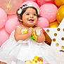 baby, child, birthday, cake, smiling, white_dress, headband, balloons, pink, gold, celebration, happy, messy, party, decorations, polka_dot, star, sitting, indoor, cute