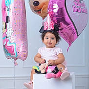 Nelly is registered to the contest to win money with this photo: toddler, birthday, balloons, minnie_mouse, pink, hat, plush_toy, studio, celebration, child, cute, smiling, party, number_one, happy, sitting, toy, girl, indoor, decor