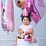 toddler, birthday, balloons, minnie_mouse, pink, hat, plush_toy, studio, celebration, child, cute, smiling, party, number_one, happy, sitting, toy, girl, indoor, decor