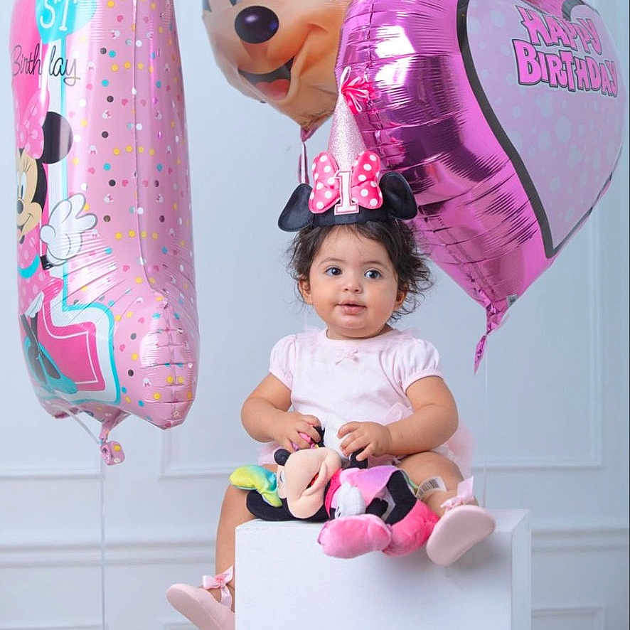 Nelly is registered to the contest to win money with this photo: balloons, birthday, celebration, child, cute, decor, girl, happy, hat, indoor, minnie_mouse, number_one, party, pink, plush_toy, sitting, smiling, studio, toddler, toy