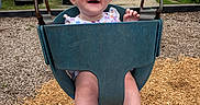 Stella joined the competition — help win amazing prizes! baby, child, swing, playground, headband, green, blue, smile, happy, outdoor, woodchips, residential, house, legs, feet, metal, seat, person, daylight, fun