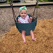 Stella is registered to the contest to win money with this photo: baby, child, toddler, swing, playground, headband, outdoor, woodchips, sitting, smiling, clothing, park, play, person, fun, summer, casual, daylight, happy, cute