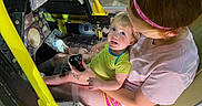 Leo joined the competition — help win amazing prizes! adult, aircraft, child, cockpit, controls, curious, glasses, headband, indoor, interaction, joystick, machine, person, playful, seat, seatbelt, shorts, technology, tshirt, yellow