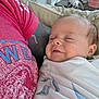baby, sleeping, blanket, arm, tattoo, red_tshirt, couch, person, indoor, relaxation, rest, infant, closeup, comfort, homedecor, furniture, table, bottle, peaceful, portrait
