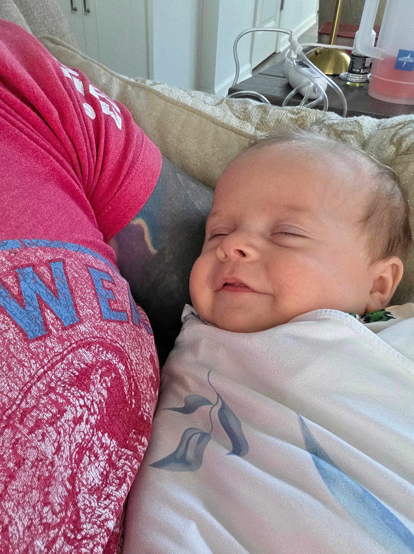 Westyn joined the competition — help win amazing prizes! baby, sleeping, blanket, arm, tattoo, red_tshirt, couch, person, indoor, relaxation, rest, infant, closeup, comfort, homedecor, furniture, table, bottle, peaceful, portrait