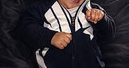Brave joined the competition — help win amazing prizes! baby, child, infant, smiling, happy, portrait, indoor, sitting, sportswear, tracksuit, beanie, nike, clothing, black_and_white, couch, fabric, face, hands, fashion, text_overlay