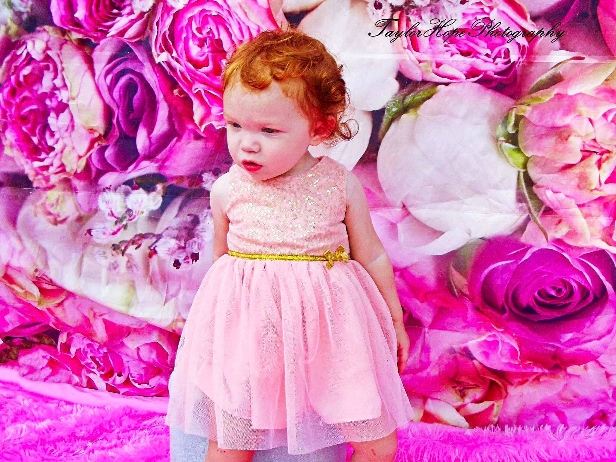Sallie is registered to the contest to win money with this photo: baby, child, child_model, cut_flowers, dress, flower, magenta, peony, person, petal, pink, plant, purple, rose, rose_family, toddler