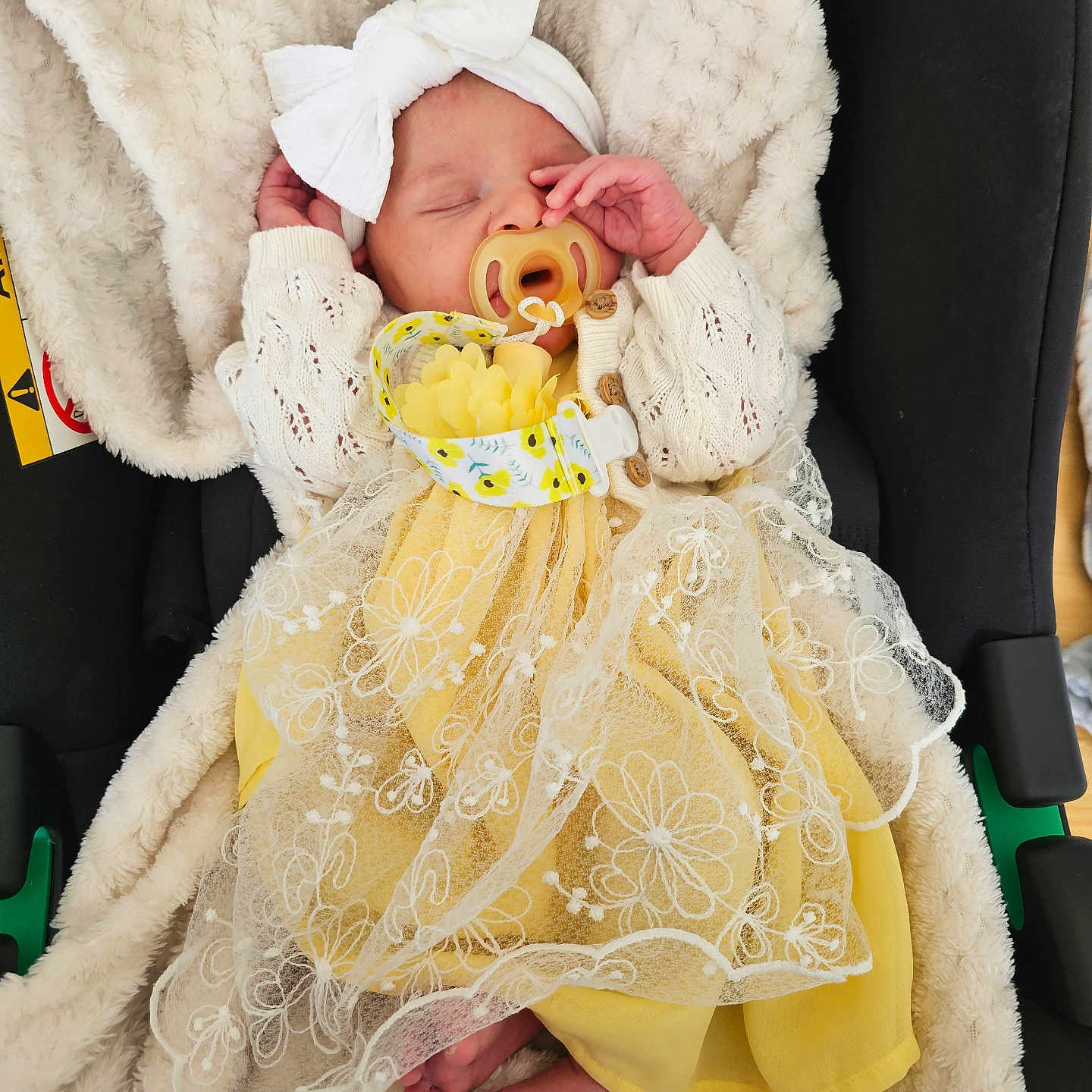 Freya is registered to the contest to win money with this photo: baby, newborn, pacifier, headband, bow, dress, yellow_dress, lace, blanket, car_seat, sleeping, infant, cute, cozy, foot, hand, clothing, soft, child, indoors
