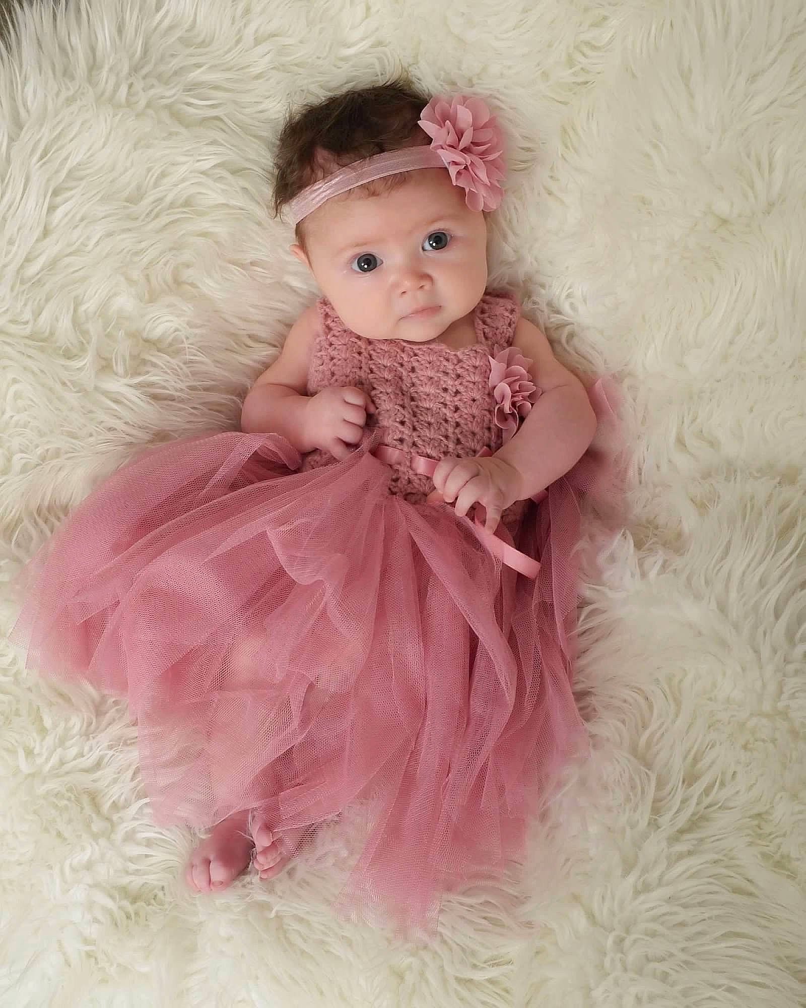 Kayleigh is registered to the contest to win money with this photo: baby_toddler_clothing, costume, costume_accessory, costume_hat, day_dress, dress, embellishment, eyelash, fashion_accessory, fashion_design, fur, hair_accessory, headpiece, headwear, magenta, one_piece_garment, pattern, peach, person, pink