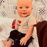 Axel joined the competition — help win amazing prizes! baby, infant, smiling, sitting, onesie, heart_graphic, denim_pants, blanket, newspaper_background, red_balloon, portrait, indoor, cute, chubby_cheeks, bare_foot, hand, big_eyes, gaze, happy, photography