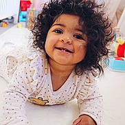 Jannah participe au concours pour gagner de l'argent avec cette photo : baby, bright, child, colorful, cozy, curly_hair, cute, face, hand, happy, indoors, infant, lying_down, polka_dot, portrait, ruffles, smiling, soft_surface, toy, young_child