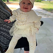 Merclynn is registered to the contest to win money with this photo: baby, child, smiling, outdoor, headband, bow, winnie_the_pooh, clothing, tights, tutu, person, happy, cute, sitting, legs, face, infant, warm_clothing, nature, daylight