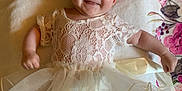 Merclynn is registered to the contest to win money with this photo: baby, smiling, flower_headband, lace_dress, infant, cute, lying_down, blanket, floral_pattern, happy, child, portrait, soft_lighting, indoors, toddler, young_child, person, head, arms, legs
