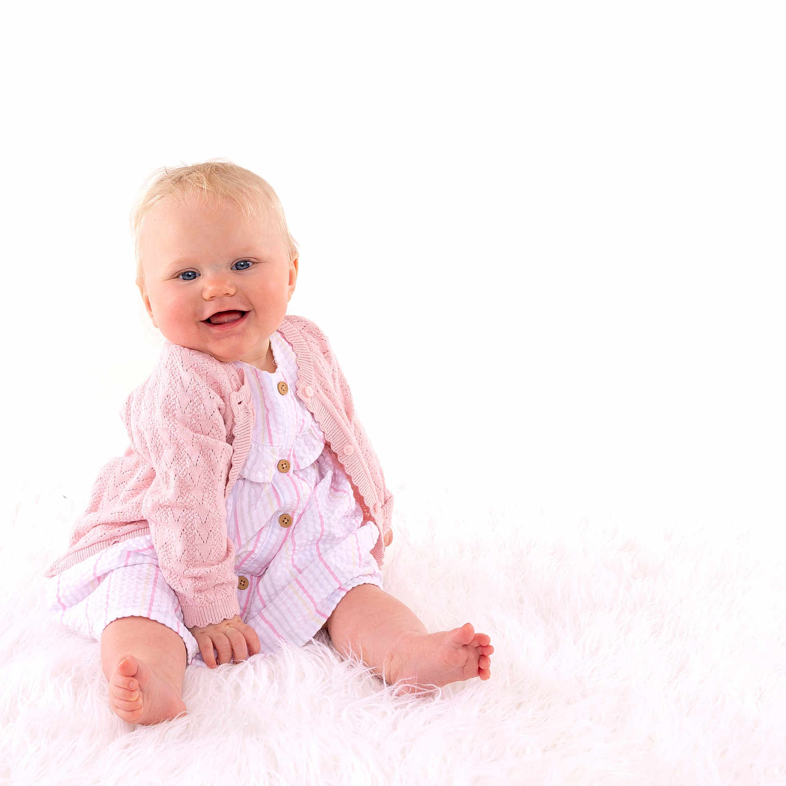 Abigail Rose is registered to the contest to win money with this photo: baby, barefoot, blue_eyes, child, cute, fluffy_rug, happy, indoors, infant, person, pink_cardigan, portrait, sitting, small_feet, small_hands, smiling, soft_lighting, striped_dress, studio_photo, white_background