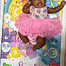 Enyla joined the competition — help win amazing prizes! baby, child, infant, portrait, smiling, happy, pink_dress, tutu, bow, headband, plush_toys, teddy_bears, rainbow, birthday, celebration, colorful, blanket, lying_down, indoor, photography