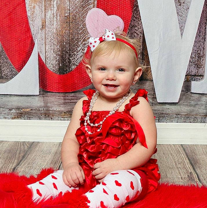 Aubrianna is registered to the contest to win money with this photo: child, christmas, costume, design, fashion_accessory, girl, hair_accessory, headgear, holiday, infant, joy, material, pattern, person, product, red, skin, smile, textile, toddler