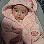 baby, infant, pink_robe, bunny_ears, cute, fluffy, child, portrait, indoors, cushion, seat, hooded_clothing, soft_texture, small_hands, wide_eyes, person, young_child, warm_clothing, expression, adorable
