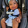 Genesis is registered to the contest to win money with this photo: baby, child, car_seat, smiling, headband, blue_headband, striped_clothing, infant, seat_belt, sitting, happy, cute, indoors, socks, closeup, person, baby_clothes, car_interior, safety, face