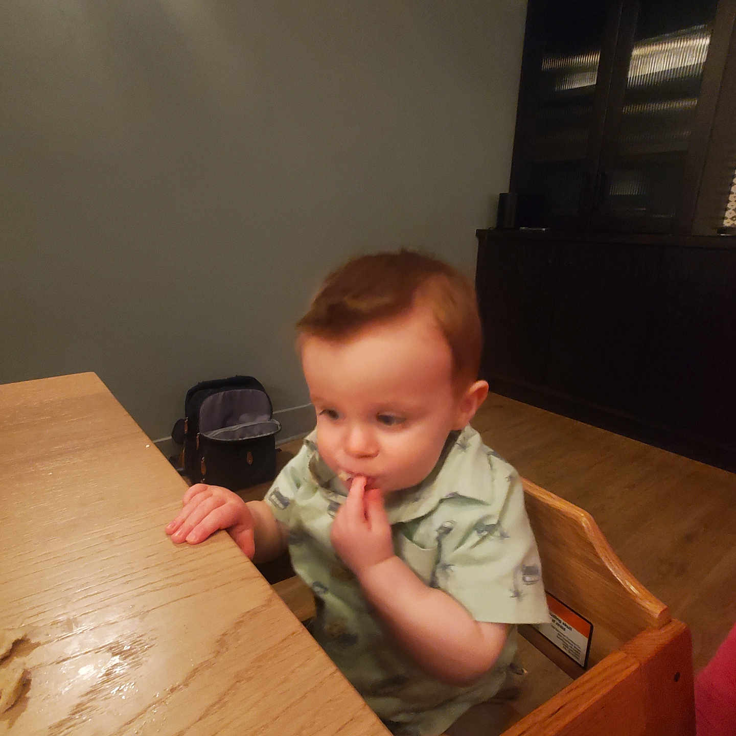 Jaxson is registered to the contest to win money with this photo: baby, bed, bodypart, bookcase, cabinet, drawer, face, finger, furniture, hand, hardwood, head, person, photography, plywood, portrait, shelf, sitting, table, wood