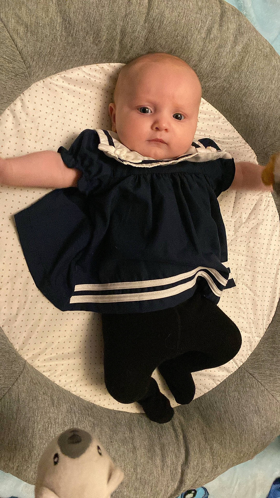 Natalia is registered to the contest to win money with this photo: baby, baby_products, baby_toddler_clothing, chair, cheek, child, collar, comfort, dress, eye, face, head, human_leg, iris, leg, pattern, person, sitting, skin, sleeve