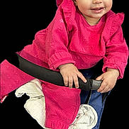 Janah participe au concours pour gagner de l'argent avec cette photo : baby, child, pink_clothing, smile, face, hand, sock, seat, blanket, blue, black_background, curly_hair, infant, happy, indoor, portrait, cute, holding, sitting, cozy